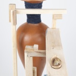 bookend to rupture, transform, repair, and care | 18.5in x 19in x 8in | reclaimed clay, reclaimed wood from shipping pallet, hand spun fiber reclaimed from discarded clothing, clay dug from the Niagara region, milkweed seed ball, milkweed tussock moth, beeswax, gold leaf, epoxy