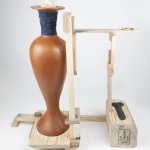 bookend to rupture, transform, repair, and care | 18.5in x 19in x 8in | reclaimed clay, reclaimed wood from shipping pallet, hand spun fiber reclaimed from discarded clothing, clay dug from the Niagara region, milkweed seed ball, milkweed tussock moth, beeswax, gold leaf, epoxy